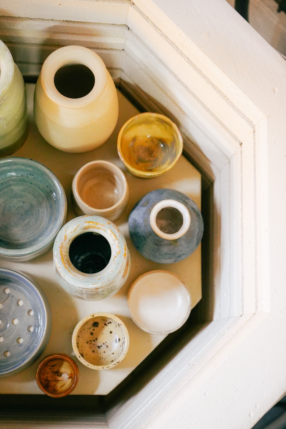 Looking down into the kiln at glazed pots after the firing