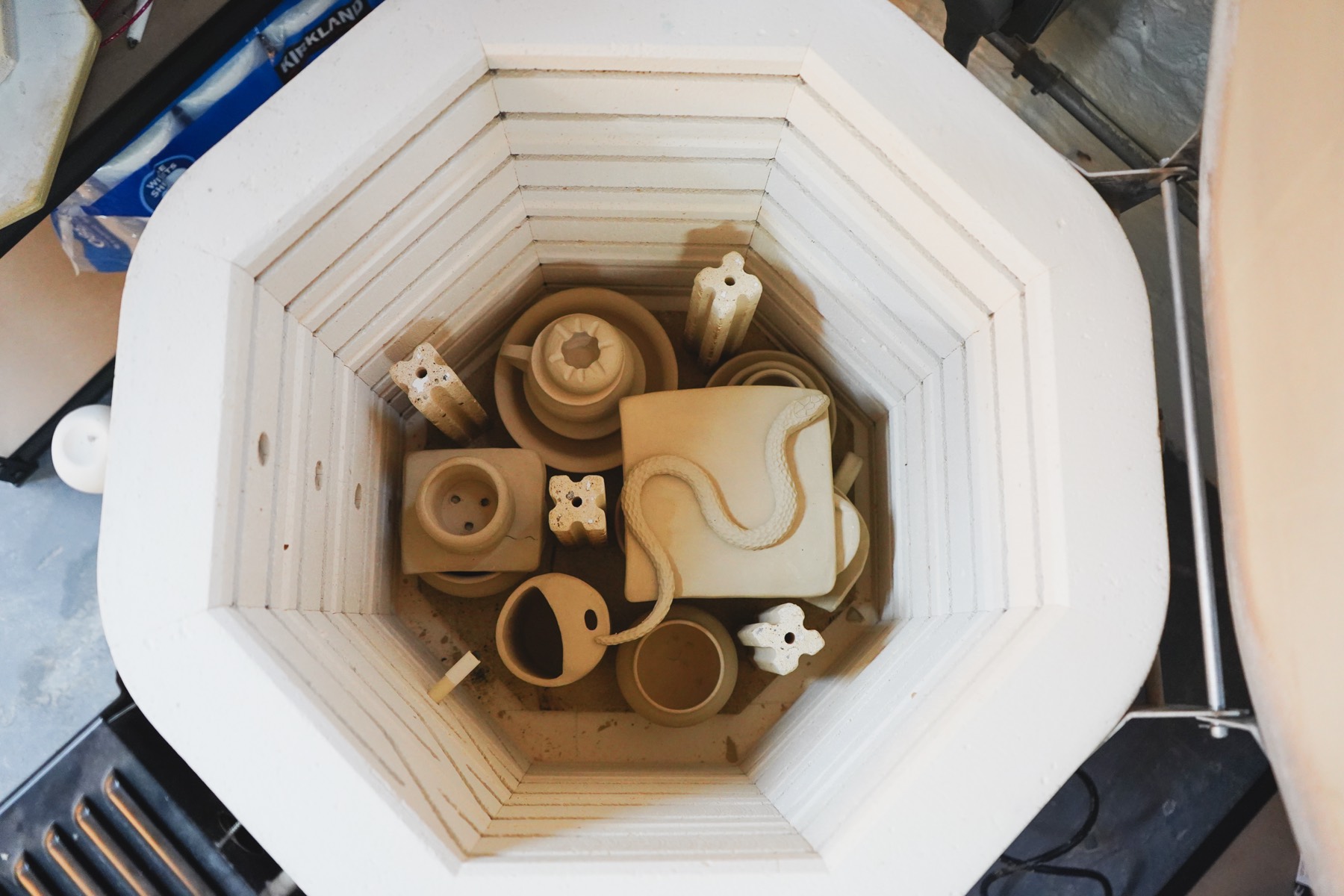 Looking down into the kiln at bisque-fired handbuilt work
