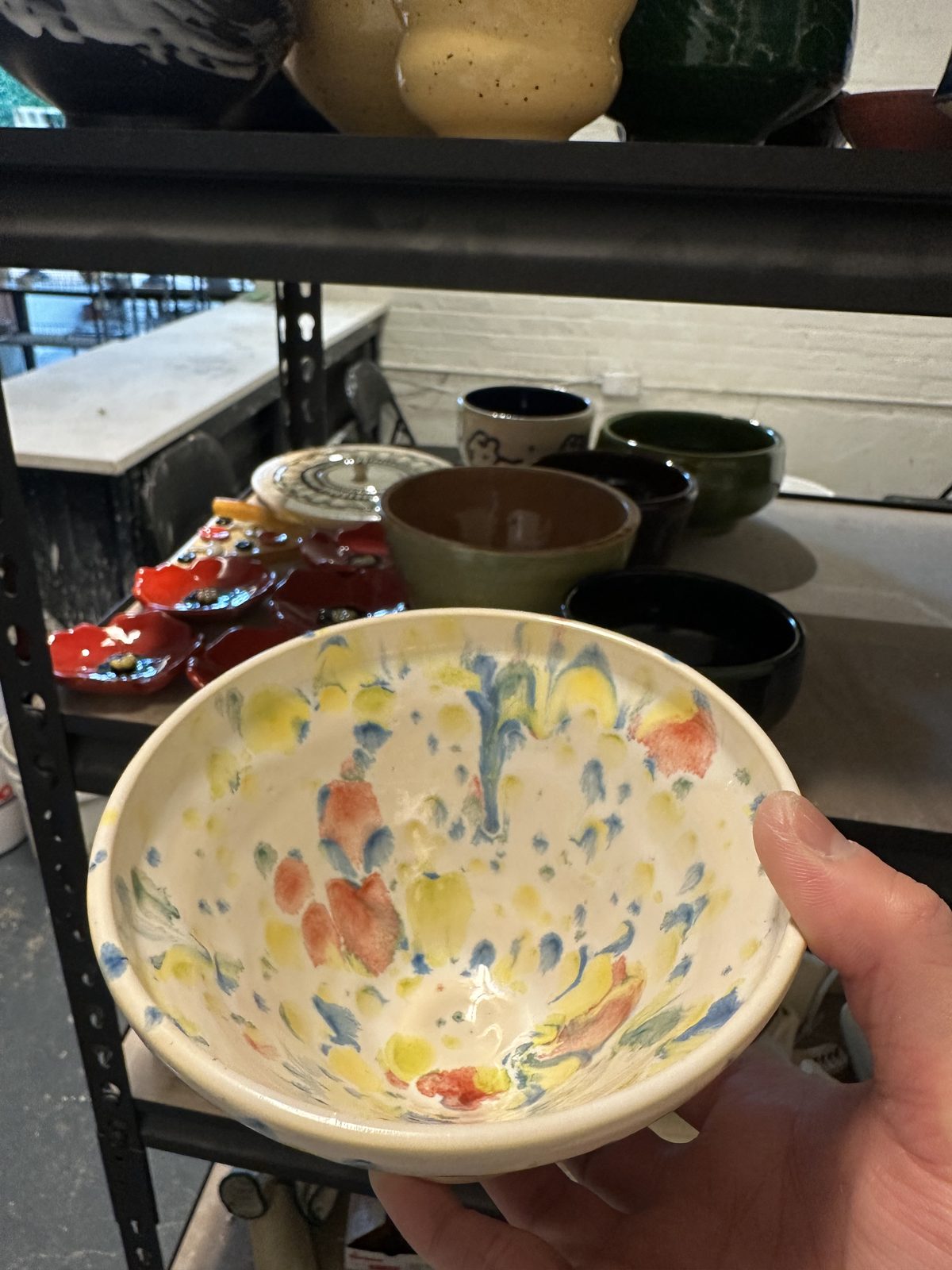 A bowl with a colorful orange and yellow speckled glaze