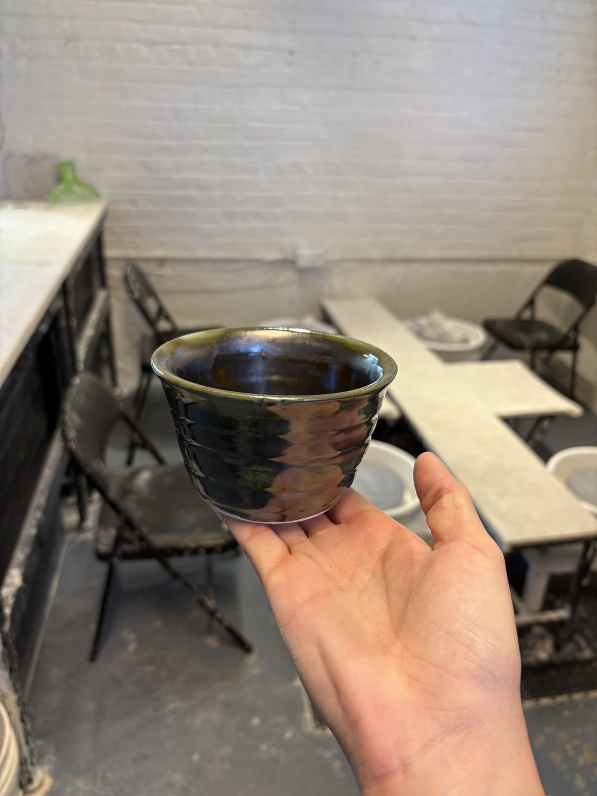A small dark handled cup